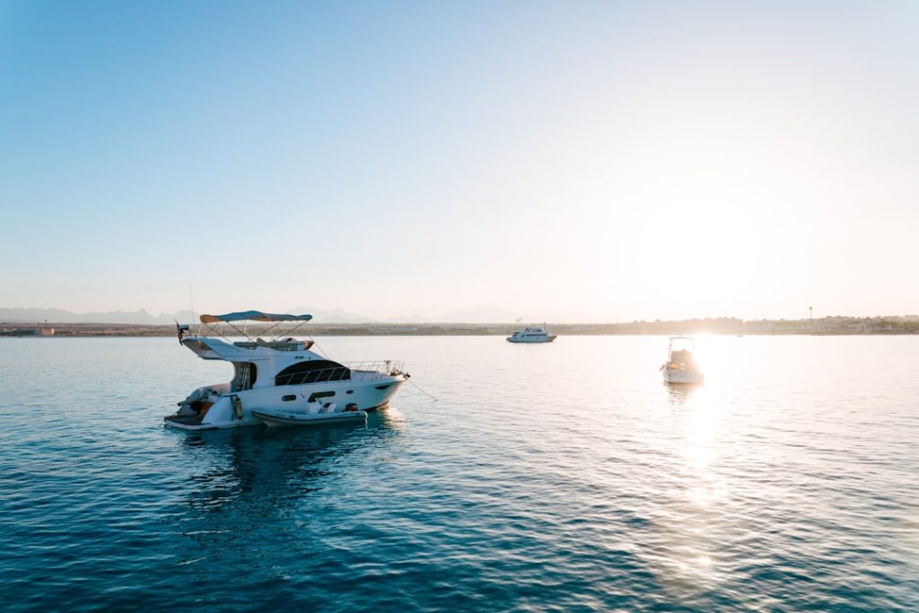 A luxurious yacht on calm waters during sunset.